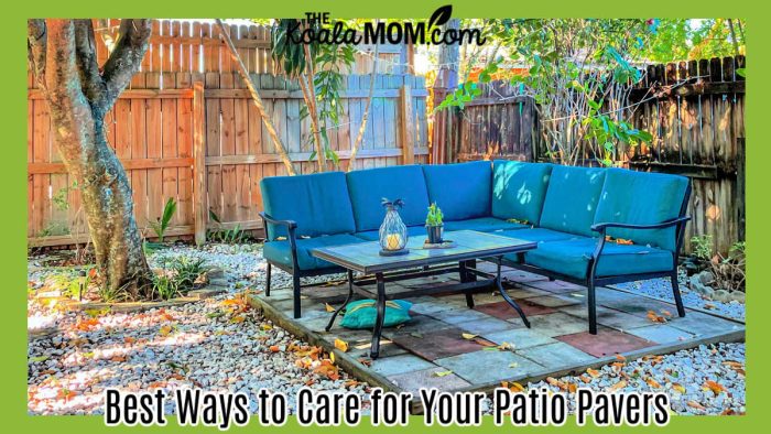 Best Ways to Care for Your Patio Pavers. Photo of teal outdoor couch with a glass coffee table on a raised stone patio with fence around it and trees overhead by Noriely Fernandez via Pexels.