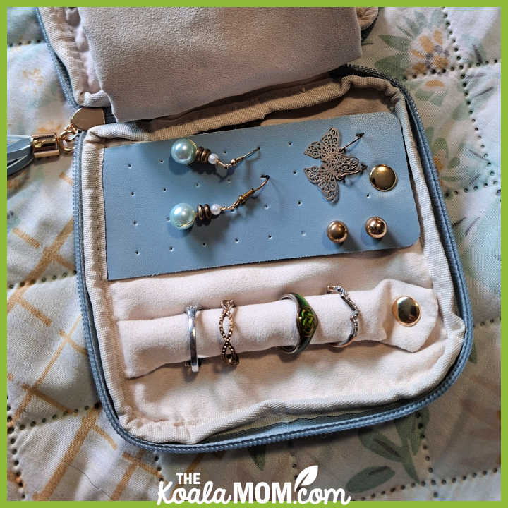 Small blue jewelry case with three pairs of earrings and several rings in it. Photo by Bonnie Way.