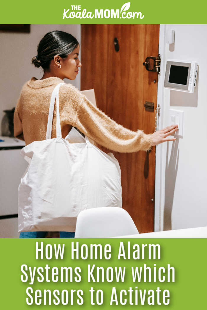 How Home Alarm Systems Know Which Sensors to Activate. Woman adjusting alarm system while holding shopping bag, showcasing a modern home lifestyle. Photo by Liza Summer via Pexels.