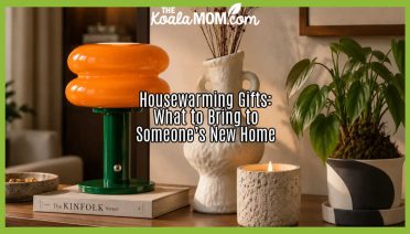 Housewarming Gifts: What to Bring to Someone’s New Home. Stock photo of orange lamp, book and other decor on side table.