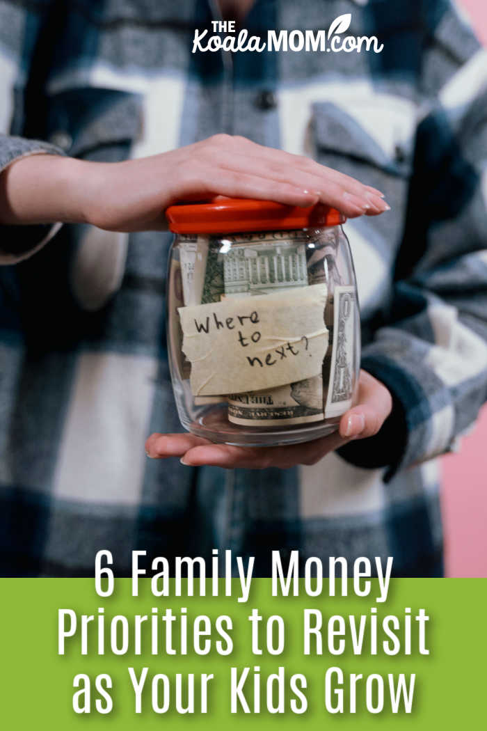 6 Family Money Priorities to Revisit as Your Kids Grow. A woman holds a jar filled with money labeled 'Where to next?' symbolizing future travel plans. Photo by Tima Miroshnichenko via Pexels.