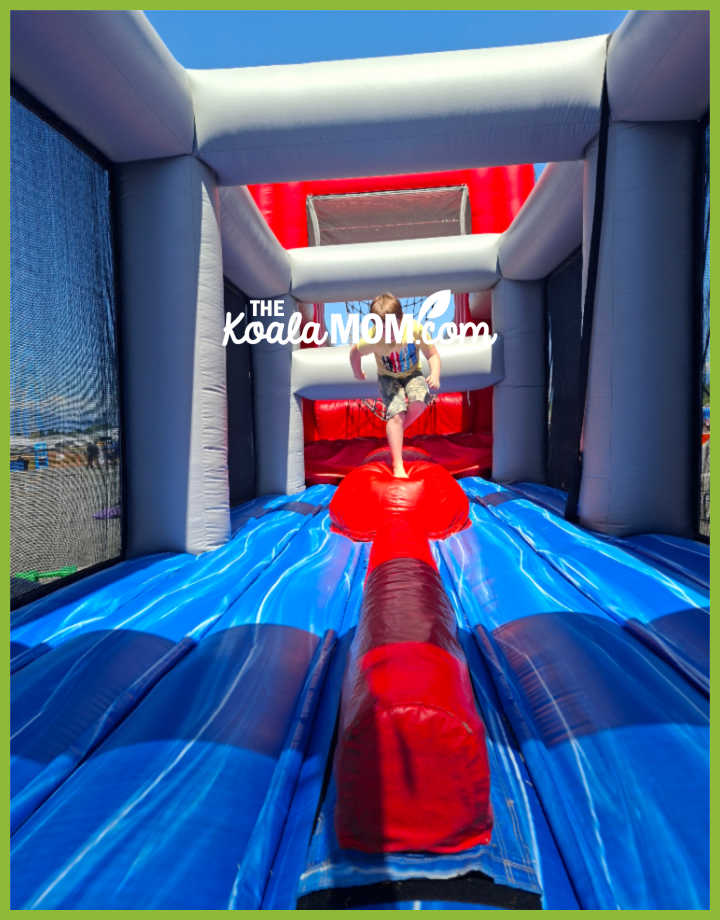 Boy run through red, blue and grey obstacle course. Photo by Bonnie Way.